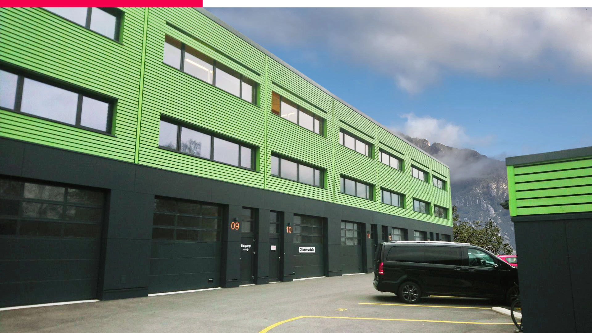 Parametric GmbH Headquarters in Wilderswil, Switzerland, featuring a building with a green and blue garage door.